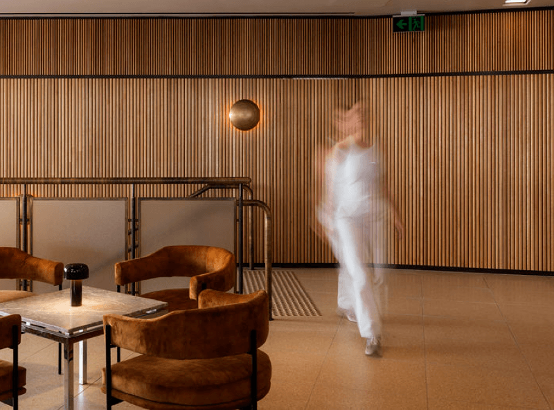 Alberts premium membership workspace with a wooden feel and women walking through the space.